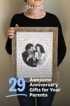 a woman holding up a framed photo with the words 29 awesome anniversary gifts for your parents