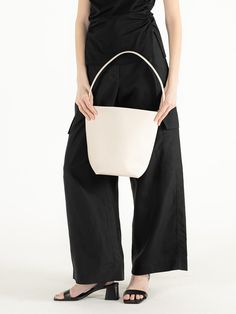 Editor's Notes object museum is a brand that develops anti-abstract and physical designs.- Textured cow leather used bucket bag- Multiple-way wearable bag- Spacious and practical design- Engraved brand logo on the front Measurements(in.)- Size: 6.69 in. / 13.19 in. * 10.63 in. * 6.30 in.- Strap: 9.45 in. Composition & Care- Cow Skin- Leather may have fine scratches and wrinkles- Bright leather can get stained by denim or dark outfits- Avoid direct heat and moisture- Wipe off m Modern Beige Leather Bucket Bag, White Bucket Bag With Leather Handles, White Bucket Bag For Evening, White Structured Shoulder Bag For Everyday Use, White Bucket Bag With Double Leather Handles, Modern Bucket Shoulder Bag For Daily Use, White Structured Bag For Everyday Use, Modern Beige Bucket Bag For Formal Occasions, Modern Hobo Bag With Bucket Shape