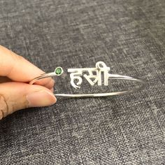 "Personalized Hindu Name Bracelet is handmade with its own uniqueness. It can be bought as a gift for any occasion like birthday gift, wedding gift, travel gift, souvenir and etc. If you need rose gold plating or yellow gold plating, please contact us, we will advice you on the additional fees applicable. Base Material: Sterling Silver Size: 11mm (Approximately) Bangle wrist size: 7'' - 8'' Inches. Adjustable / Please give us your wrist circumference. Stone: Red CZ setting (Default) Or check wit Customized Meaningful Name Bracelet As Gift, Meaningful Customized Name Bracelet As Gift, Customized Meaningful Name Bracelet For Gift, Meaningful Silver Name Bracelet As Gift, Customized Sterling Silver Name Bracelet Gift, Name Engraved Bangle Bracelet For Gift, Sterling Silver Name Bracelet Gift, Customized Silver Name Bracelet As Birthday Gift, Customized Silver Name Bracelet For Birthday Gift