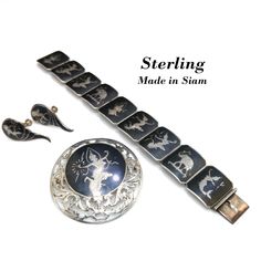 *Description: This is a sterling silver bracelet, brooch, and screwback earrings with black enamel from the 1930s.  Siam's name was officially changed to Thailand in 1939.  These pieces have never been worn but have natural patina on the silver. This would be a great addition to your vintage jewelry collection or make a great vintage gift! *Reference: Brief history of the designs: It is technically Niello or Nielloware, created by carving out areas of the silver, and baking a sulfur/metals powde Antique Jewelry With Polished Finish For Evening, Evening Antique Jewelry With Polished Finish, Hallmarked Sterling Silver Jewelry For Evening, Sterling Silver Hallmarked Jewelry For Evening, Hallmarked Sterling Silver Evening Jewelry, Art Deco Formal Jewelry With Screw Back, Traditional Evening Jewelry Brooch, Formal Art Deco Jewelry With Screw Back, Traditional Evening Brooch Jewelry