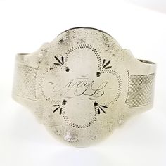 "Description: An antique silver cuff bracelet with embossed and hand engraved embellishments. The front has and engraved monogram NYL. Unmarked but tested to be at least coin silver which is 900 silver. The opening is flexible and easy to put on and remove. The shape can be adjusted for any size wrist by your local jeweler for a final fit. Circa 1850's - 1870's. Weighs 15.2 grams. Measurements: The inside diameter measures 2\" at the widest and fits on a average sized wrist. Condition: Good with Engraved Cuff, Antique Coins, Wire Bangles, Stacked Bangles, Sterling Silver Filigree, Gold Art, Hinged Bangle, Silver Filigree, Silver Cuff Bracelet