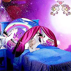 a child's bedroom with pink and purple walls, blue bedspread, and an unicorn themed tent