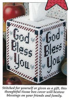 a cross stitched tissue box with the words god has you written on it and an apple next to it