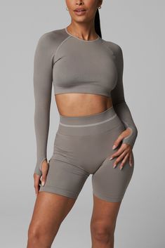 Introducing LiCi's True Form collection, a seamless activewear line that serves as a reminder to be true to yourself. Crafted with a fabric that feels silky smooth to the touch, and enhanced with a full interlocking knit construction, this collection offers the perfect combination of compression and breathability. Full Coverage Double Lined Crew Neckline With Removable Pads Cropped Length Back Cut-Out Design Ribbed Band Detail for Extra Support LiCi Logo placement center top back Fabric: Seamles Solid Tops For Gym With Micro-elastic Fit, Micro-elastic Solid Tops For Gym, Micro-elastic Solid Color Gym Tops, Micro-elastic Solid Tops For Workout, Solid Tops With Micro-elastic Fit For Gym, Nylon Seamless Compression Activewear, Nylon Compression Activewear With Seamless Design, Versatile Workout Tops, Micro-elastic Sportswear Tops For Yoga