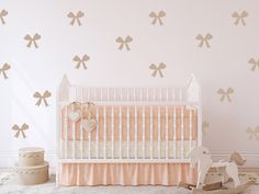 a baby's room with wall decals and a crib in the foreground