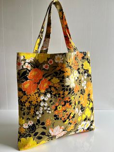 - Measures 15" x 15" with a 8.5" handle drop. - I have handmade this tote out of a stunning vintage barkcloth fabric.  - The interior is an orange cotton with a two patch pocket made from textured floral vintage fabric. - Double lined with high quality interfacing. Vintage Yellow Tote Shoulder Bag, Vintage Green Cotton Bag, Vintage Green Cotton Shoulder Bag, Green Vintage Cotton Shoulder Bag, Vintage Handmade Canvas Bag For Daily Use, Vintage Yellow Tote Bag, Retro Brown Cotton Bag, Vintage Yellow Bag For Everyday Use, Vintage Orange Shoulder Bag For Shopping