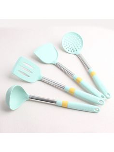 five kitchen utensils are arranged on a white surface