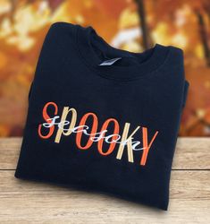 Spooky Season Halloween Sweatshirt is so colorful and fun with Pumpkin and Gold lettering for the fall season.   Gildan 18000 comfortable sweatshirts with embroidered design.  May be substituted if out of stock with another quality brand.  We always offer customization.  Just message me with any request. - Gildan 18000 Unisex sizing - Embroidered design Please message me with any questions! Fall Sweatshirts Cricut, Black T-shirt With Embroidered Logo For Fall, Black Embroidered Logo T-shirt For Fall, Black T-shirt With Custom Embroidery For Fall, Black Sweatshirt With Custom Embroidery For Fall, Embroidered Black T-shirt For Fall, Black Embroidered T-shirt For Fall, Embroidery Designs Shirts, Sweatshirts Cricut