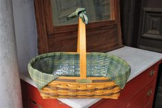 a wicker basket sitting on top of a red dresser