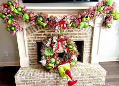 a christmas wreath is hanging on the fireplace