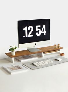 a computer monitor sitting on top of a desk next to a wooden keyboard and mouse