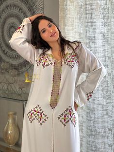 introducing the Jellaba sozan - a unique and stylish representation of traditional Moroccan fashion. Crafted from high-quality mlefa and meticulously handmade, this Jellaba exudes luxury and class, making it the perfect choice for those who want to stay fashionable and chic while proudly showcasing their culture and heritage Luxury Long Kaftan For Eid, Elegant White Kaftan With Traditional Patterns, Elegant Long Sleeve Kurta With Traditional Patterns, Elegant Long Sleeve Thobe For Traditional Ceremonies, Elegant Long Sleeve Abaya For Traditional Ceremonies, Long Sleeve Thobe With Dabka Work For Traditional Ceremonies, Elegant Long Sleeve Kaftan With Traditional Patterns, Festive White Long Sleeve Abaya, White Long Sleeve Thobe With Dabka Work