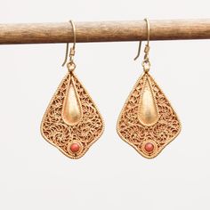 Coral set on filigree work 24k vermeil earrings Approximate dimensions; L 1.65 X W 0.75 Inches Yellow Gold Filigree Plug Earrings, Traditional Yellow Gold Chandelier Earrings With Filigree, Traditional Yellow Gold Filigree Chandelier Earrings, Ornate 22k Gold Earrings, Gold Plated Pendant Earrings With Intricate Design, Ornate 22k Gold Earrings With Intricate Design, Gold Plated Filigree Jewelry In Gold, 22k Gold Teardrop Jewelry Gift, Gold Plated Filigree Teardrop Jewelry