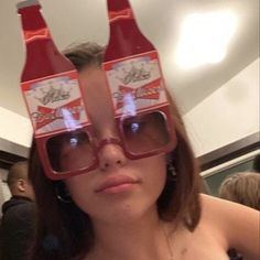 a woman wearing glasses with coca cola bottles on her head and the eyes are half closed