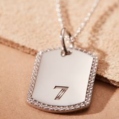 A new spin on our best-selling Mini Dog Tag necklace. We took the necklace you know and love, and upgraded it with pavé-set stones and rounded edges. Whether it’s a monogram or special number, engrave them with details that matter most. Best part? Keep adding tags when you like! option to engrave 1-3 rows, uppercase only dog tag measures 20.4mm x 13.1mm CZs are .9mm hangs on adjustable length 1.3mm cara cable chain also available in 14k yellow gold back engraving not available Luxury Monogram Silver Necklace, Luxury Silver Monogram Necklace, Engraved White Gold Dog Tag Necklace, Luxury Silver Dog Tag Jewelry, Elegant Jewelry Dog Tag With Initials, Initials Dog Tag Jewelry For Anniversary, Luxury Sterling Silver Necklace With Engraving Option, Luxury Silver Necklace With Engraving Option, Tiny Tags