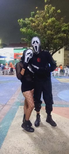 two people dressed in costumes standing next to each other