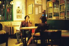 two people sitting at a table in a restaurant