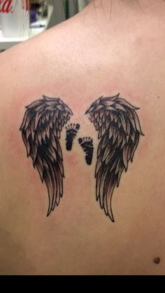 an angel wing tattoo on the back of a woman's upper arm and foot