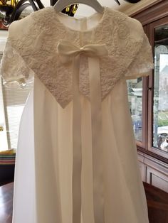 "FREE SHIPPING IN THE U.S. and reduced shipping rates for International orders. This beautiful gown is grandmother's wedding dress conversion, but it can be made new from similar fabric from my shop. Satin bodice with puffed sleeves and a scalloped lace edge. Organza skirt also has the scalloped lace edge. Beautiful large collar in the front with a bow (optional) Satin ribbon ties in the back of the waist. Bridal looping and satin buttons close the back. Matching bonnet included. Gown is made he Lace Ball Gown For Confirmation, Cream Organza Dress For Baptism, Organza Baptism Dress With Lace Bodice For Wedding, Cream Organza Gown For Wedding, Cream Organza Wedding Gown, Cream Organza Dress For Ceremony, Baptism Dress With Fitted Bodice, Ball Gown Shape, Baptism Dresses With Fitted Bodice In Ball Gown Shape, Fitted Bodice Ball Gown For Baptism