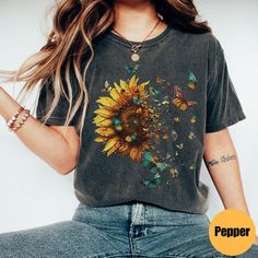 "Sunflower Butterfly Shirt | Flowers Gift T-Shirt | Love Butterfly Shirt | Mom Shirt | Flower Shirt | Butterfly Tee | Floral Tee Matching Sweatshirt: https://printworkshopcompany.etsy.com/listing/1680976420/sunflower-butterflies-sweatshirt ** HOW TO ORDER 1. Check our photos for sizing and color options.  2. Select your size and color from the drop-down menus.  3. Click \"ADD TO CART\" to add the shirt to your cart. 4. Click \"PROCEED TO CHECKOUT\" to purchase your shirt. ** VIP Email List Be su Cute Short Sleeve T-shirt With Plant Print, Trendy Relaxed Fit T-shirt With Sunflower Print, Cute Floral Graphic Print Tops, Multicolor Sunflower Print Short Sleeve Top, Cute Floral Print Short Sleeve T-shirt, Casual Multicolor Sunflower Print Tops, Casual Short Sleeve Shirt With Sunflower Print, Casual Crew Neck Shirt With Sunflower Print, Cute Floral Print Relaxed Fit Tops