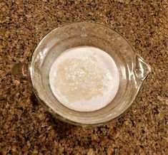 a glass bowl filled with liquid on top of a counter