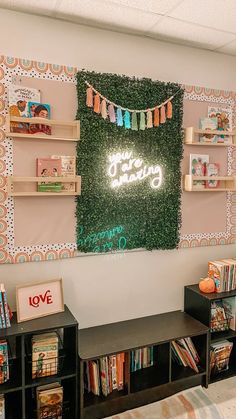 a room with bookshelves, shelves and a sign on the wall that says happy birthday