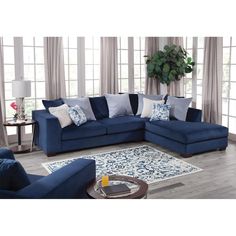 a living room with blue couches and pillows