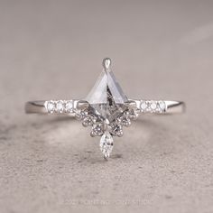 an engagement ring with a pear shaped diamond