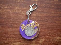 Genuine Japanese coin in Resin This one of a kind keychain was crafted with genuine materials to give it an authentic and unique finish.  We know that your journey is unique and so are you. That's why we always use genuine foreign coins and real pressed flowers so that no two pieces are exactly alike. Find something that tells your story! View our entire collection of foreign coin keychains and jewelry in our shop! Ships in 1-3 business days. Free shipping in the USA! Handmade Silver Keychains For Gifts, Handmade Silver Keychain As Gift, Handmade Silver Keychain For Gift, Handmade Gold Keychains For Gifts, Symbolic Collectible Coin Jewelry, Handmade Silver Keychain For Personal Use, Traditional Multicolor Pouch Coin Purse, Japanese Coin Purse, Purple Resin