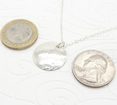 "This lightweight small sterling silver disc necklace was handmade by me. I used my small size (3/4 inch diameter) of silver disk and hammered it to give it a reflective, shiny, and attractive surface that just glows. It is comfortable and especially pretty with its sterling cable chain. The sterling silver has a great shine, and is a small 3/4\" diameter (19 mm). The necklace in the picture has an 18\" (45.7 cm) sterling silver cable chain, and other sizes are available during checkout for a hi Hammered Sterling Silver Coin Necklace, Hammered Round Sterling Silver Coin Necklace, Round Sterling Silver Hammered Coin Necklace, Hammered Silver Coin Necklace In Sterling Silver, Silver Hammered Round Coin Necklace, Silver Hammered Coin Necklace, Silver Sterling Coin Necklace With Round Disc, Silver Hammered Coin Necklace As Gift, Disc Earrings