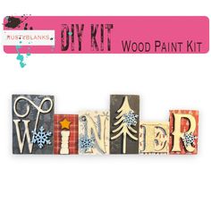 the word winter written in wooden blocks with snowflakes and trees on them, next to a pink ribbon