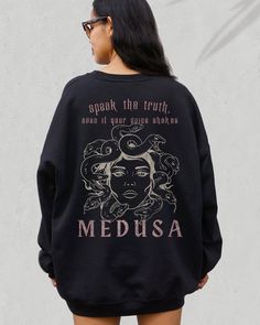 🐍THE GOTHIC MEDUSA BACK PRINT SWEATSHIRT 🐍 We are super excited for you to get your hands on this Medusa quote and design sweatshirt. The garment is very on trend, mixing the dark academia vibe with a Medusa quote in a gothic style. We hope you like it! Perfect for yourself or as a gift.  If you would like to discuss colour options for anything that isn't available in the listing, please let us know and message us directly.  THIS DESIGN IS ALSO AVAILABLE AS A T SHIRT: ➡️ ➡️ ➡️ https://www.etsy.com/listing/1491961613/medusa-shirt-greek-mythology-medusa ✨ ABOUT OUR CREWNECK SWEATERS ✨ Our crewneck sweaters are pure comfort and very soft. They are available in various different colors, as per the listing options. If you like the oversized look, like in some of our photos, please purchase be Oversized Graphic Print Sweatshirt Fan Apparel, Fan Apparel Hoodie Sweatshirt With Graphic Print, Oversized Fall Sweatshirt With Back Print, Oversized Sweatshirt With Back Print For Fall, Greek Goddess Medusa, Goddess Medusa, Snake Hoodie, Snake Sweater, Mythology Medusa