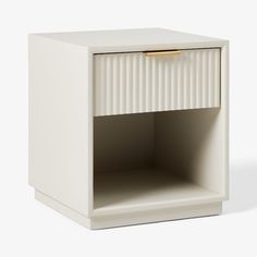 a white nightstand with a gold handle on it