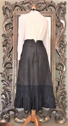 Authentic Victorian Silk Walking Skirt. Lined Black Full Length Skirt with Ruffle/Frill Detail around the Hem.Fastens with Press Studs. Waist is small , as expected but could be made bigger by adding an etra flap at the opening, or adding Tie fastening if so desired.There is some damage to the Silk, and some damage on the inside,( not surprising considering it's age) but the Piece is still sturdy and Wearable.Would make a Fab  Goth/Steampunk/Witches or Vampire Halloween/Black Widow /Victorian Gh Black Bohemian Midi Skirt, Gothic Fitted Skirt For Fall, Steampunk Skirt For Party, Gothic Fitted Bottoms With Ruffled Skirt, Black Steampunk Skirt For Party, Gothic Long Ruffled Skirt, Gothic Fitted Skirt, Gothic Skirt For Fall Costume Party, Gothic Long Ruffled Skirt Bottoms