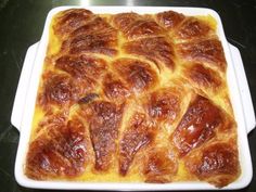 a square casserole dish filled with meat and cheese on a black counter top