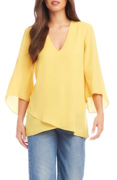 An elegant top of silky, lightweight crepe delivers elegant movement with its angled flare sleeves and fluttery asymmetrical hemline that dips low in back. 25 1/2" length (size Medium) V-neck Three-quarter sleeves Back yoke with gathering Crossover high/low hem 100% polyester Dry clean or hand wash, line dry Made in the USA of imported fabric Women's Clothing Flowy Spring Blouse With Asymmetrical Hem, Flowy Blouse With Asymmetrical Hem For Spring, Flowy Asymmetrical Hem Blouse For Spring, Elegant Stretch Top With Asymmetrical Hem, Elegant Stretch Tops With Asymmetrical Hem, Chic Viscose Tops With Asymmetrical Hem, Chic Viscose Top With Asymmetrical Hem, Chic Flowy Blouse With Asymmetrical Hem, Spring Stretch Blouse With Asymmetrical Hem