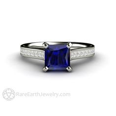 a blue sapphire and diamond engagement ring with channel set diamonds on the sides, in 18k white gold