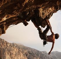 a man climbing up the side of a mountain