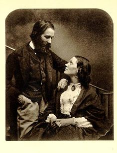 an old black and white photo of a man with a beard next to a woman