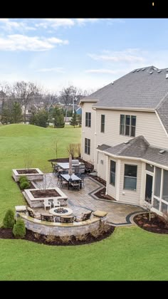 an aerial view of a house with a patio and seating area in the front yard