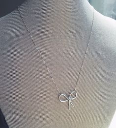 Silver Knot Necklace, Knot Jewelry Tie the Knot Necklace Tie the Knot Jewelry Love Knot Necklace Bridesmaid Gift under 20 Bridesmaid Jewelry This listing is for 1 silver dainty matte silver knot necklace on a sterling silver chain. The knot measures 24mmx22mm. Choose length at checkout. Card can be customized. Giftbox included. This is one of my best sellers! Also available in gold: https://www.etsy.com/listing/505707584/gold-knot-necklace-knot-jewelry-tie-the?ref=shop_home_active_1 Necklace Tie, Knot Jewelry, Jewelry Knots, Love Knot Necklace, Bow Necklace, Bow Jewelry, Silver Bow, Tie The Knot, Wedding Jewellery Necklace