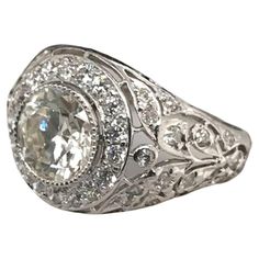 a white gold ring with an oval cut diamond in the center