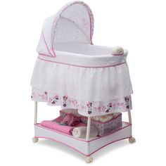 a white baby crib with pink trim