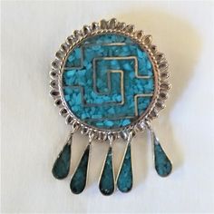 Vintage Native American made, signed by the highly skilled artist, brooch that can also be worn as a pendent. The brooch has age related wear so please make sure to view the pics close up. This intricate brooch consists of inlaid turquoise and sterling silver. Antique Handmade Blue Brooches, Turquoise Cabochon Brooch As A Gift, Turquoise Cabochon Brooch For Gift, Artisan Collectible Jewelry Brooch, Handmade Vintage Turquoise Brooches, Unique Handmade Turquoise Brooch, Handmade Turquoise Brooches For Collectible, Unique Handmade Turquoise Brooches, Turquoise Brooch Jewelry Gift