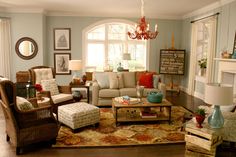 a living room filled with furniture and a chandelier