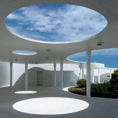 an empty room with white walls and round windows on the ceiling is seen in this image