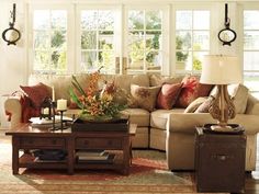 a living room filled with furniture and lots of windows