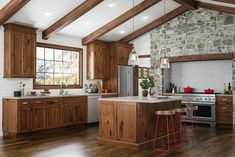 a kitchen with wooden cabinets and an island in the middle, along with two stools