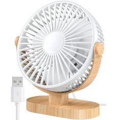 an electric fan is plugged into the charger on a wooden stand with a usb cable