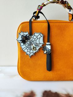 an orange purse with a spider on it